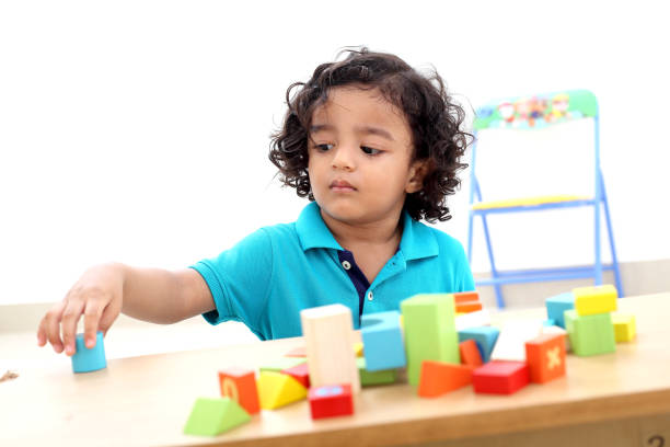 Adorable child playing with wooden blocks-Child development