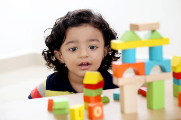 Adorable child playing with wooden blocks-Child growth