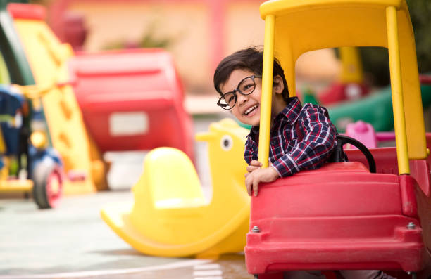 Preschool boy having fun in toy car