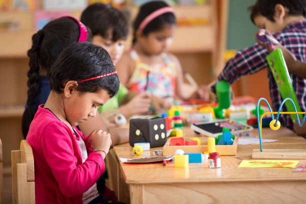 Preschool children painting and drawing with watercolor